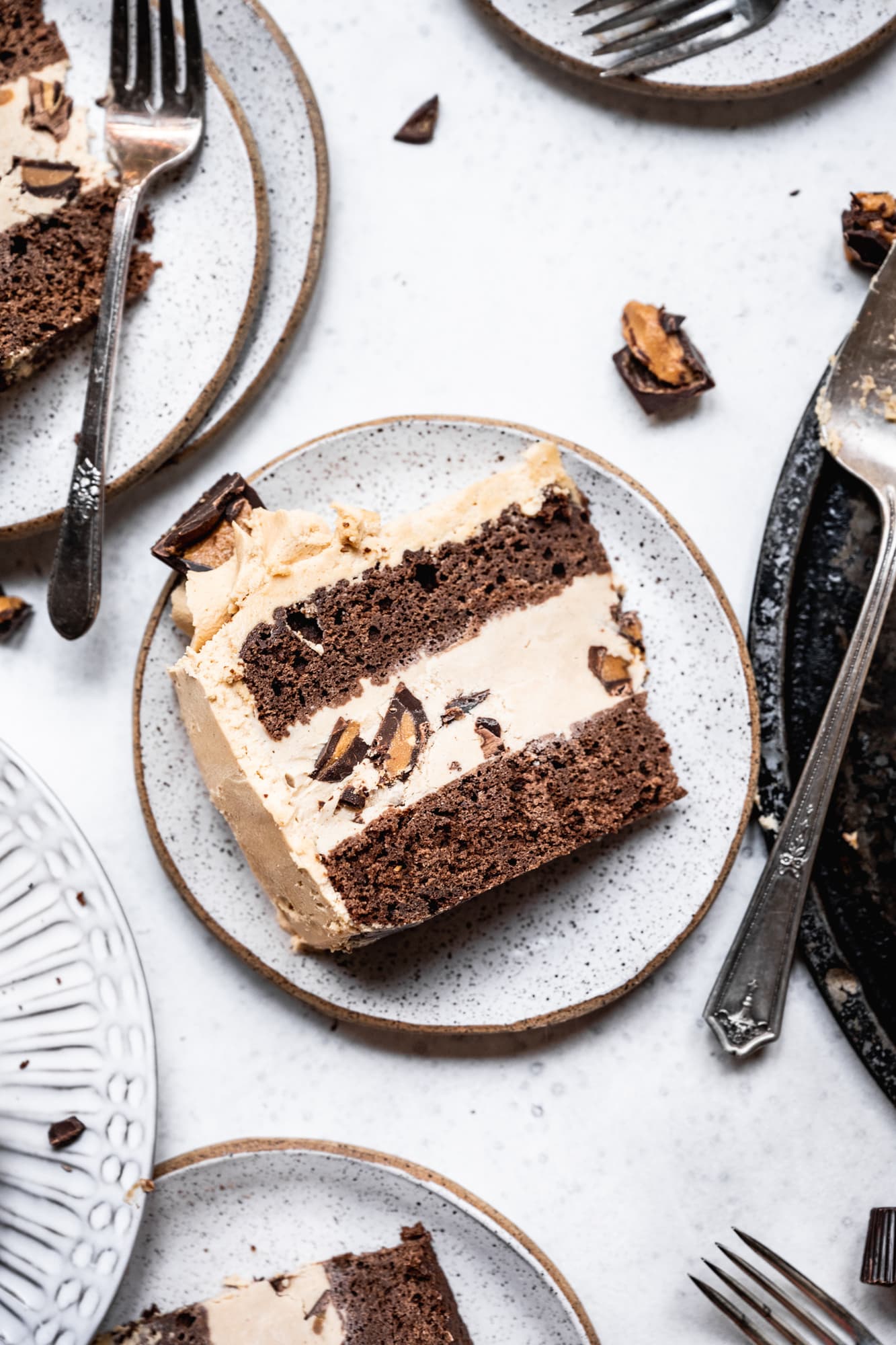 overhead view of chocolate peanut butter ice cream cake slices on white plates