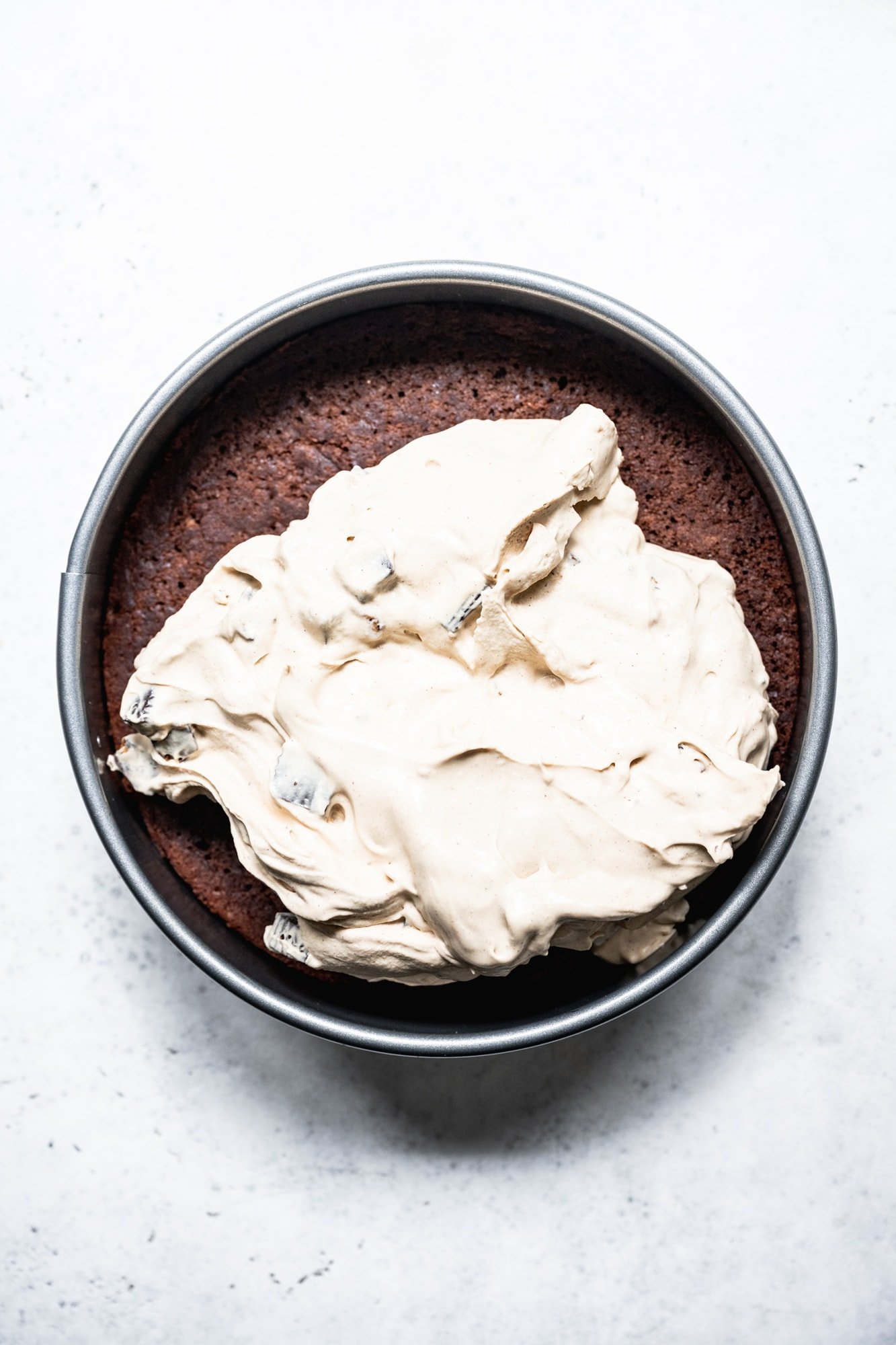 overhead view of peanut butter ice cream and chocolate cake in cake pan