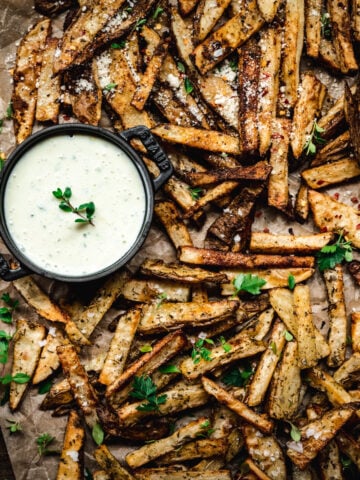 overhead view of crispy homemade fries on parchment paper