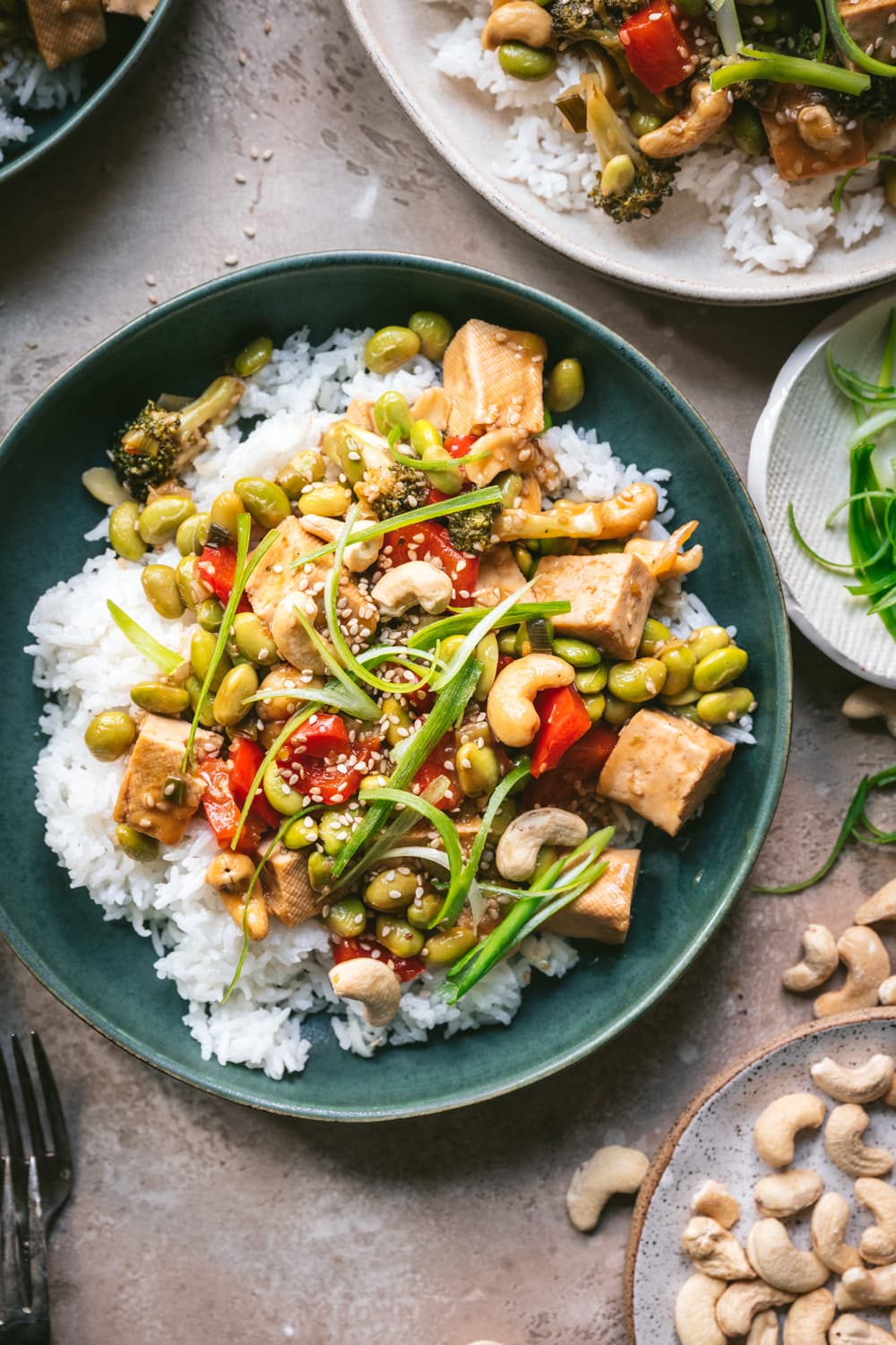 overhead view of pineapple teriyaki tofu served over rice in blue bowl