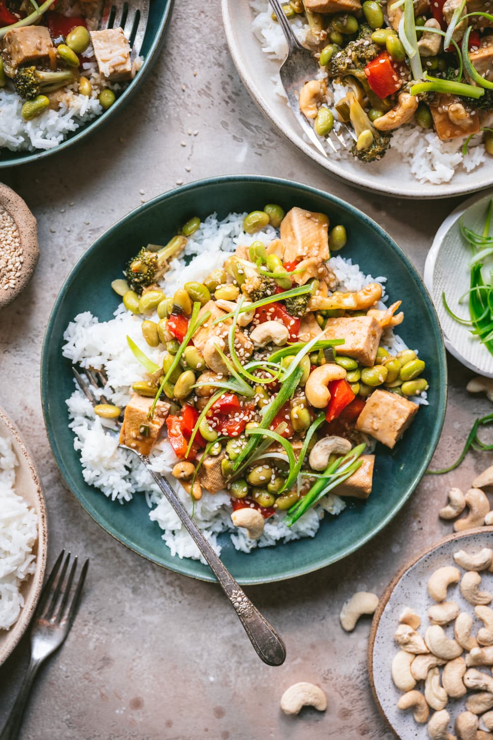 overhead view of pineapple teriyaki tofu served over rice in blue bowl