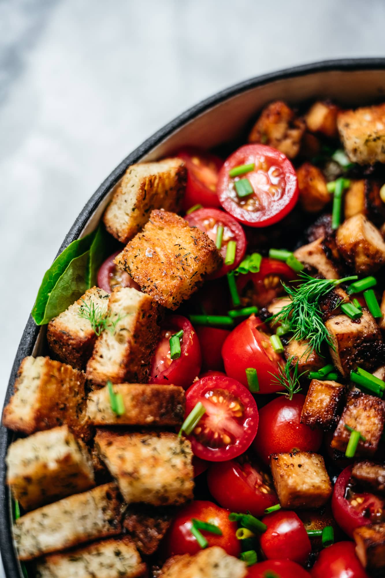 close up view of garlic dill croutons on a salad