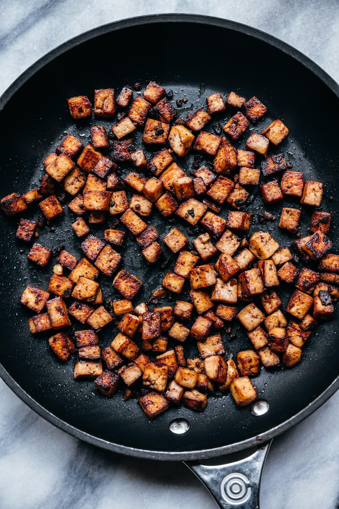 overhead view of crispy vegan tofu bacon bits in pan