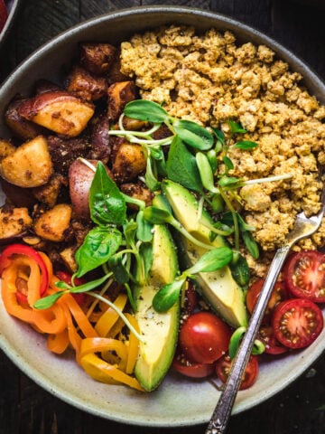 overhead view of savory vegan breakfast bowl with potatoes and scrambled tofu