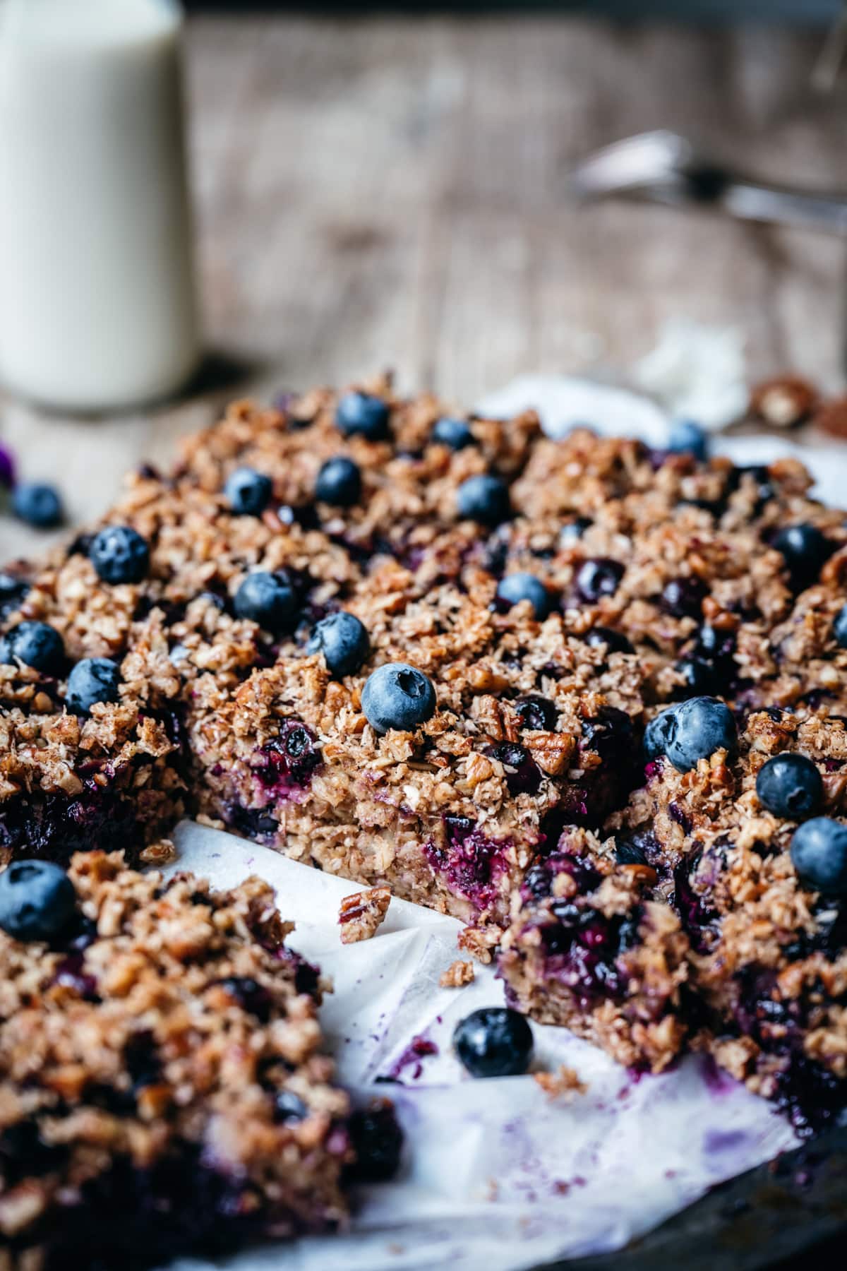 side view of blueberry oatmeal bake on parchment paper