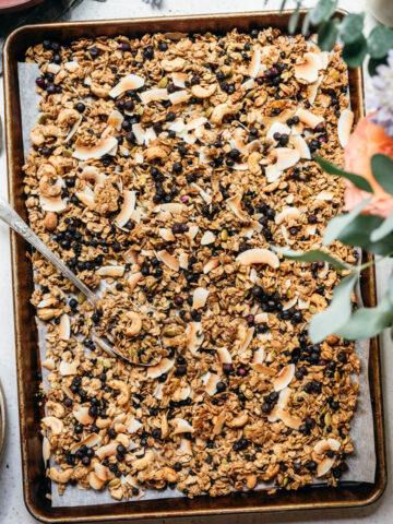 overhead view of vegan lemon blueberry coconut granola on a sheet pan