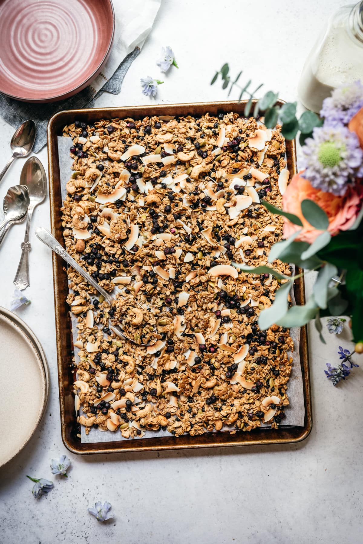 overhead view of vegan lemon blueberry coconut granola on a sheet pan