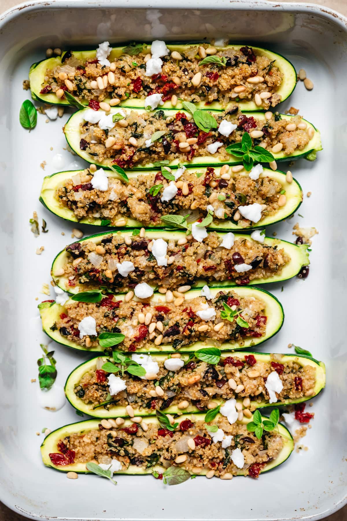 overhead view of vegan quinoa stuffed zucchini boats in pan