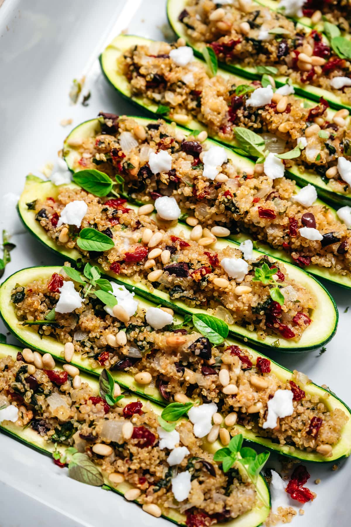 side view of quinoa stuffed zucchini boats in pan