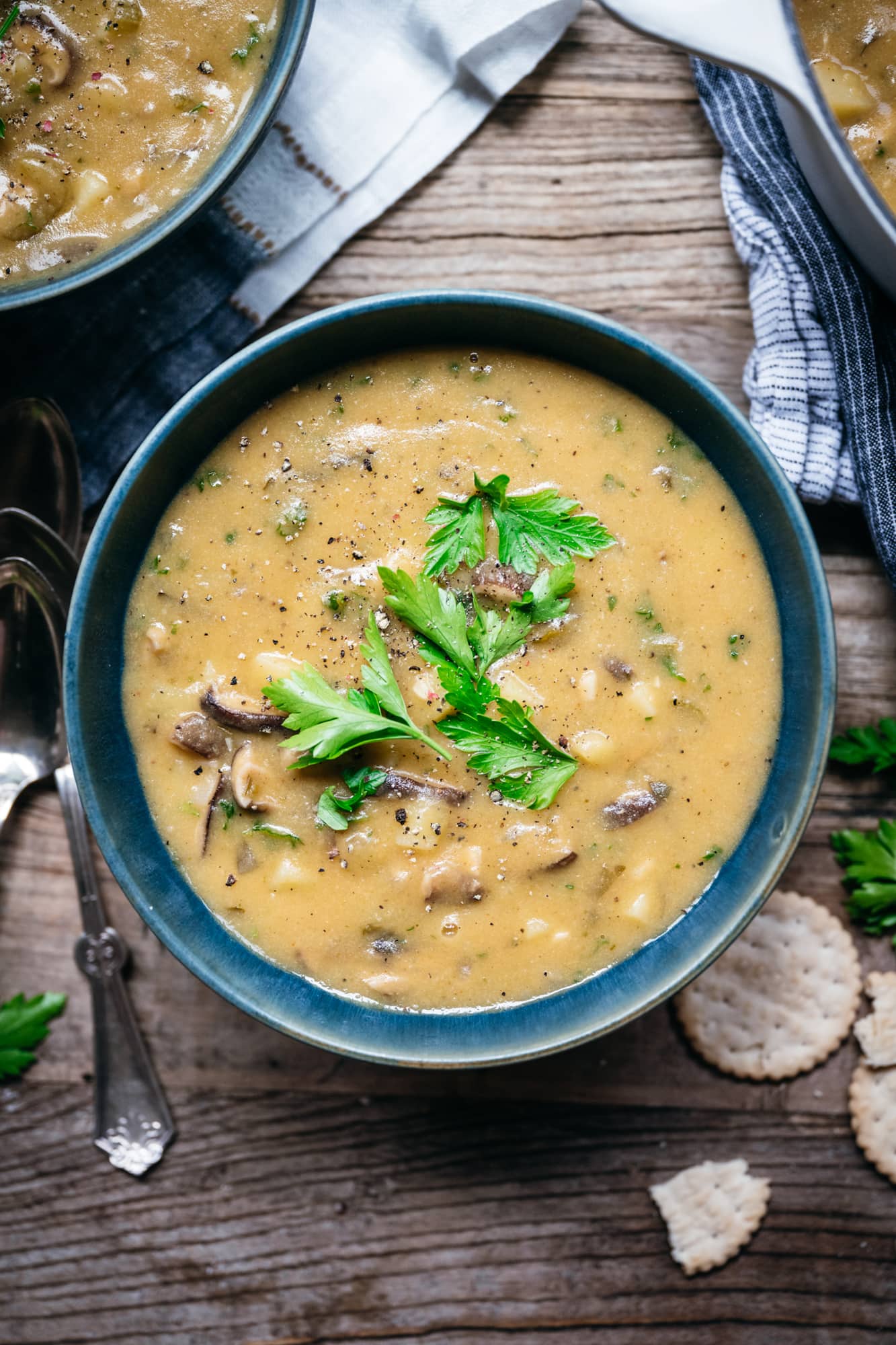 overhead view of vegan mushroom clam chowder in a blue bowl