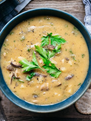 overhead view of vegan mushroom clam chowder in a blue bowl