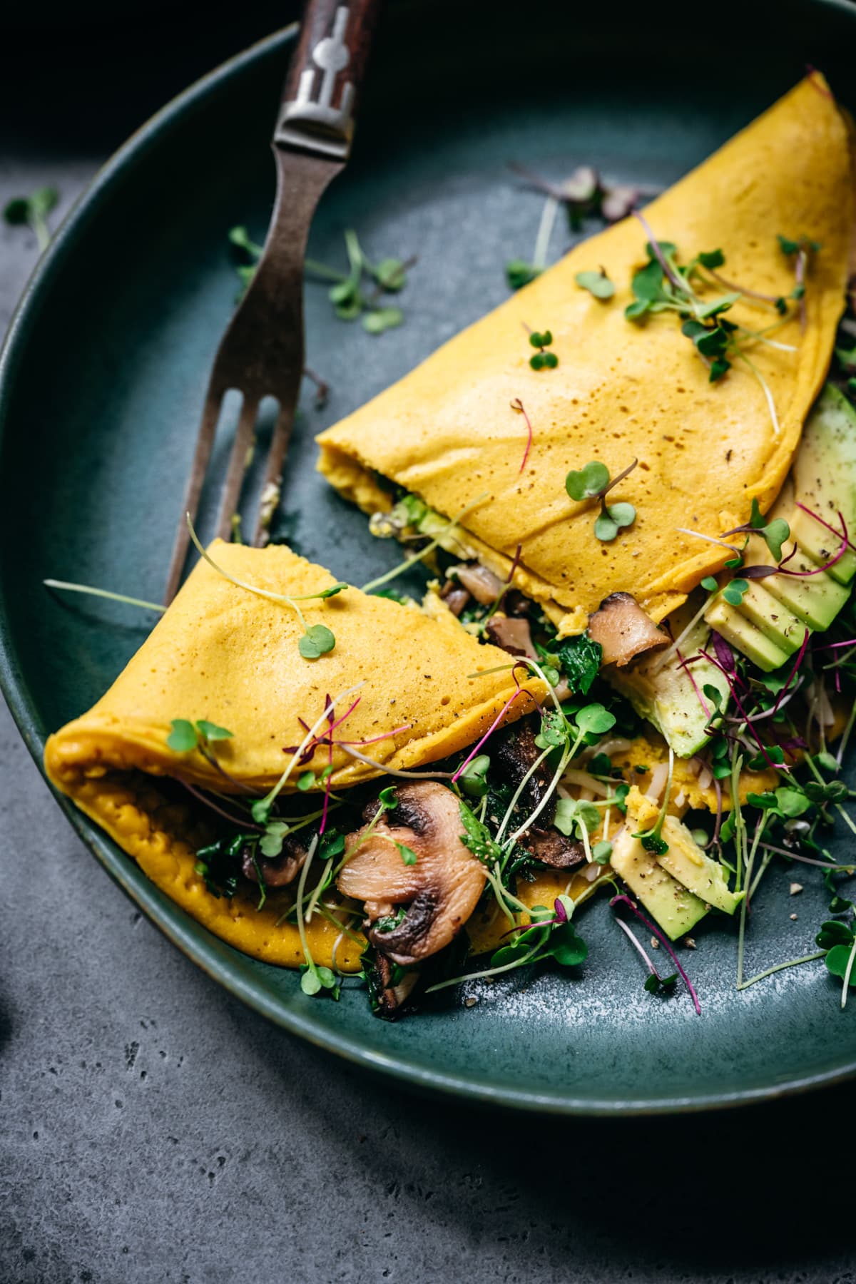 close up view of piece of vegan omelette and fork.