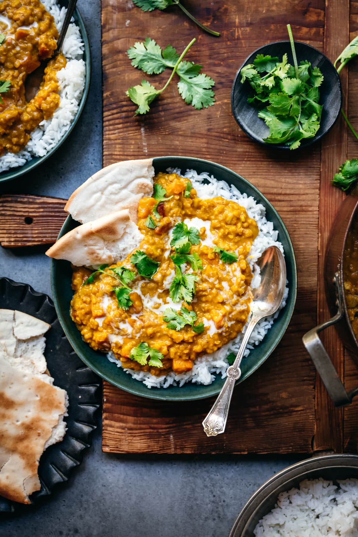 overhead view of bowl with white rice and vegan red lentil dal toped with fresh cilantro.