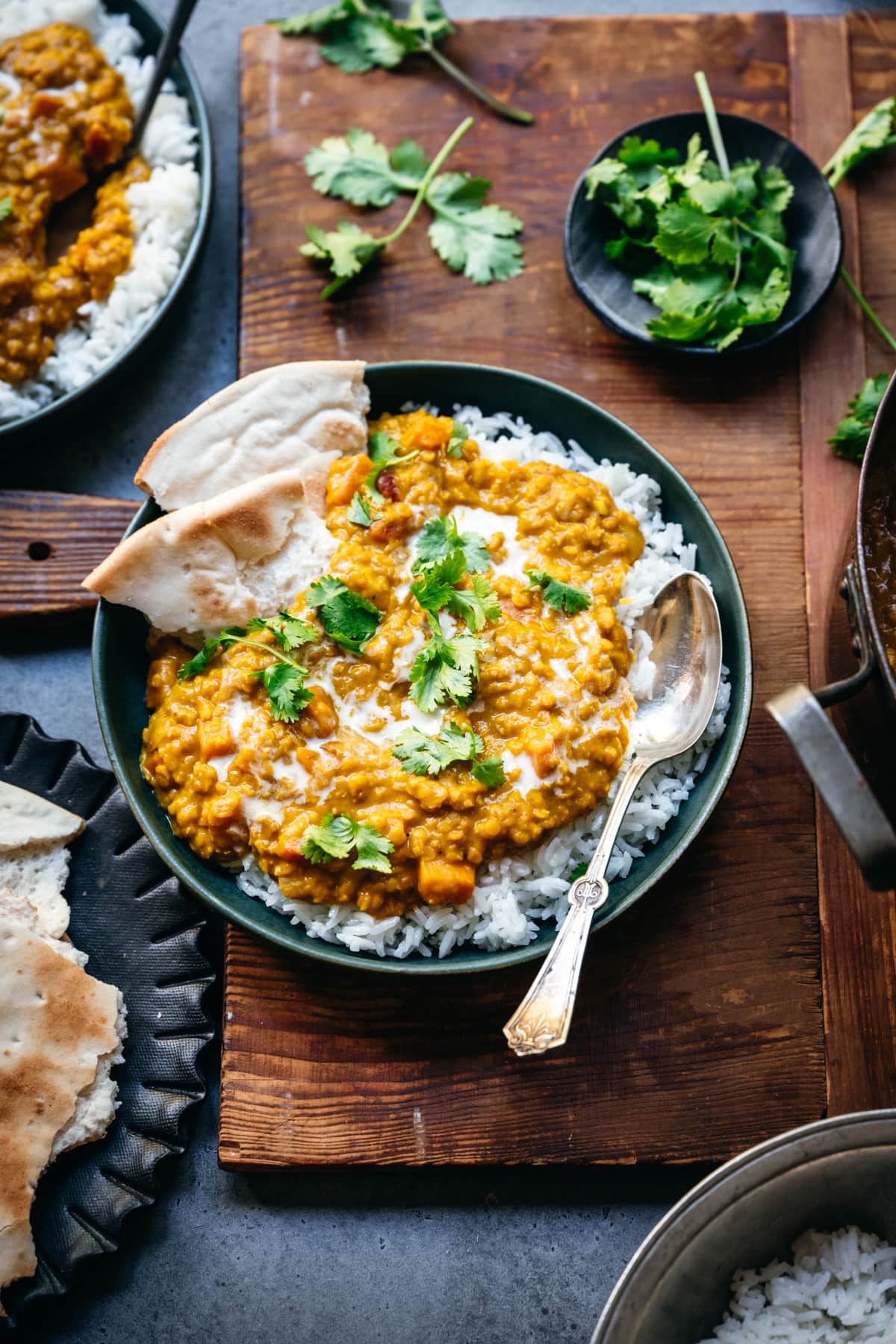 overhead view of bowl with white rice and vegan red lentil dal toped with fresh cilantro.