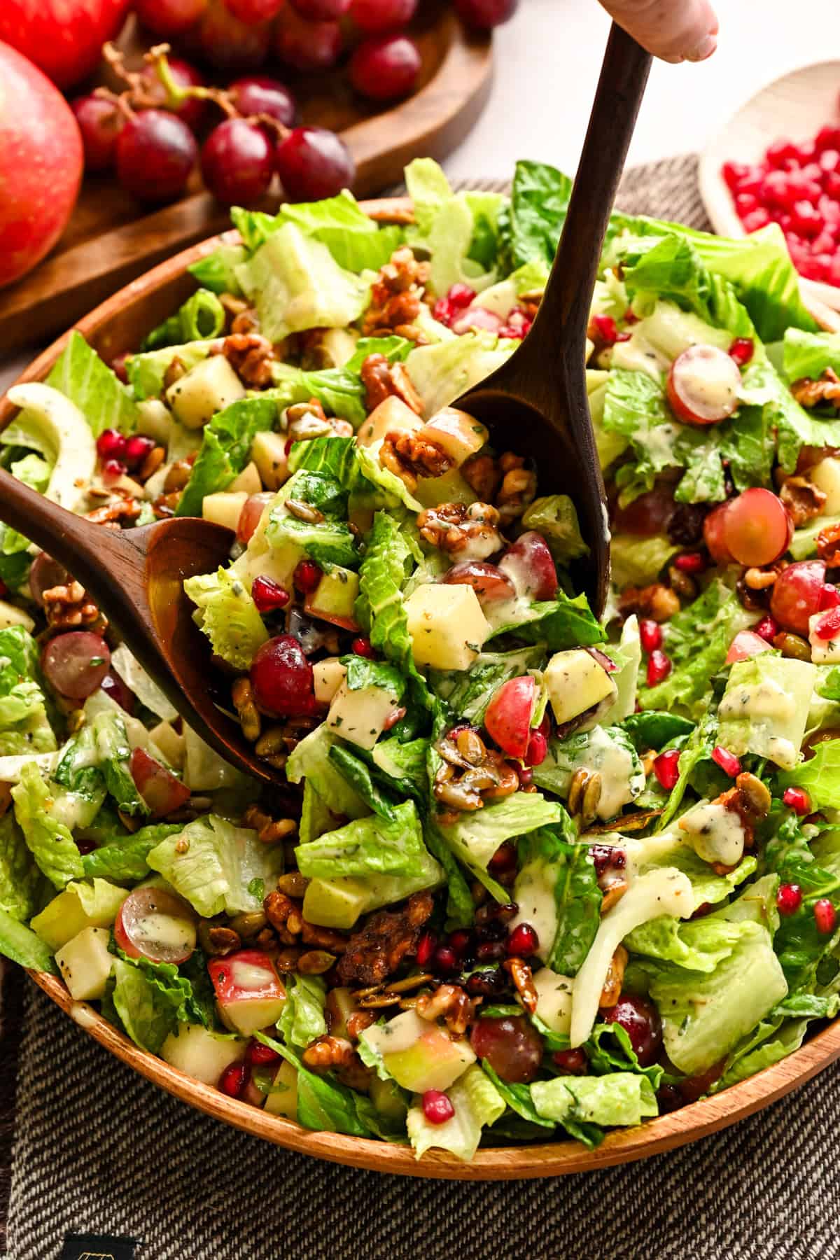 Close up view of waldorf salad being scooped up with utensils.