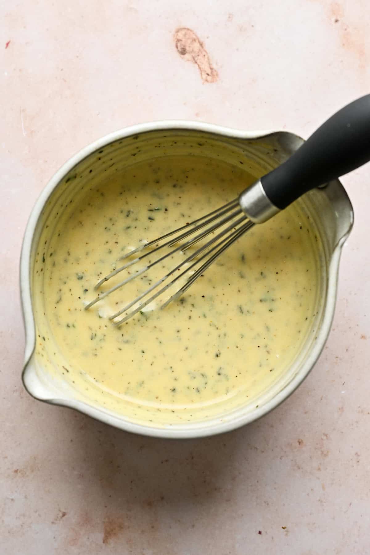 Overhead view of salad dressing in a bowl.