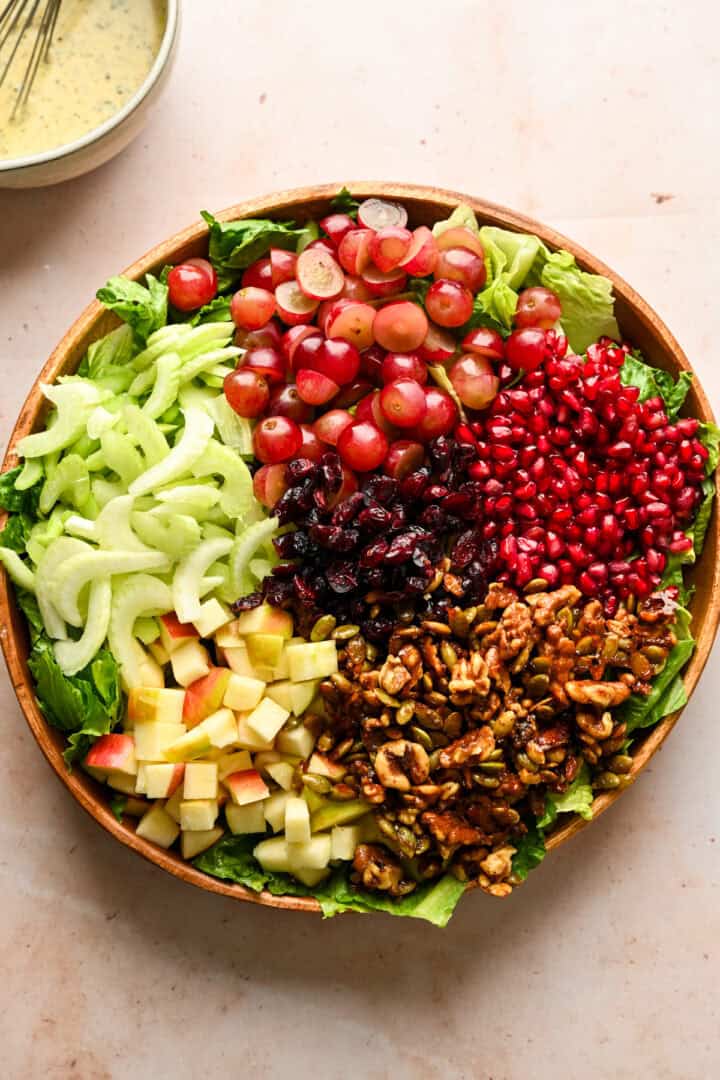 Overhead view of waldorf salad ingredients in a bowl before mixing them together.