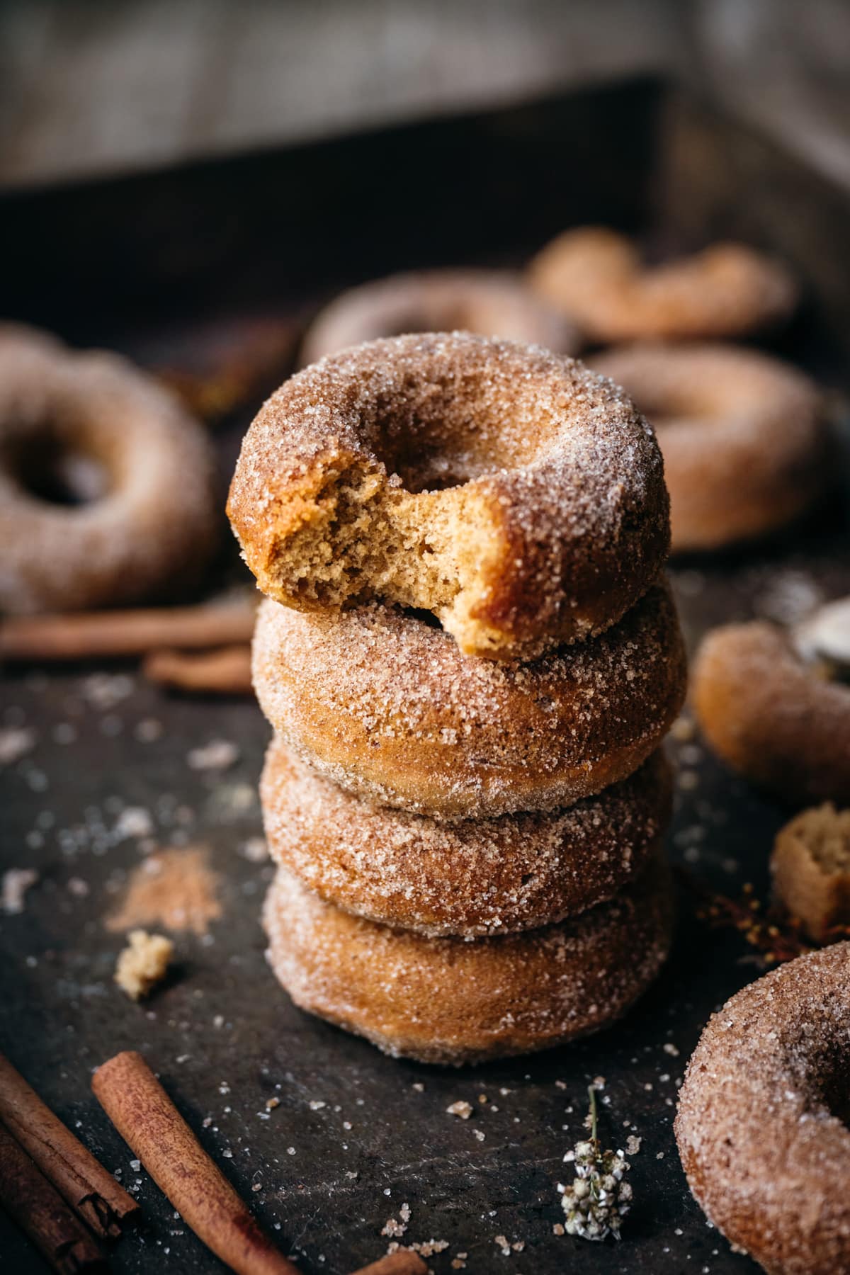 side view of a stack of vegan apple cider donuts.