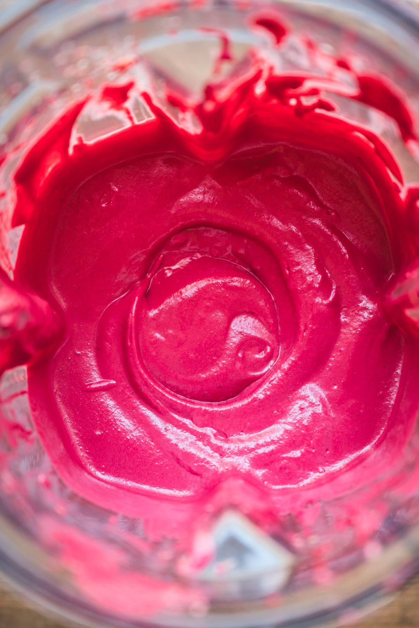 close up overhead view of creamy beet pasta sauce in a blender