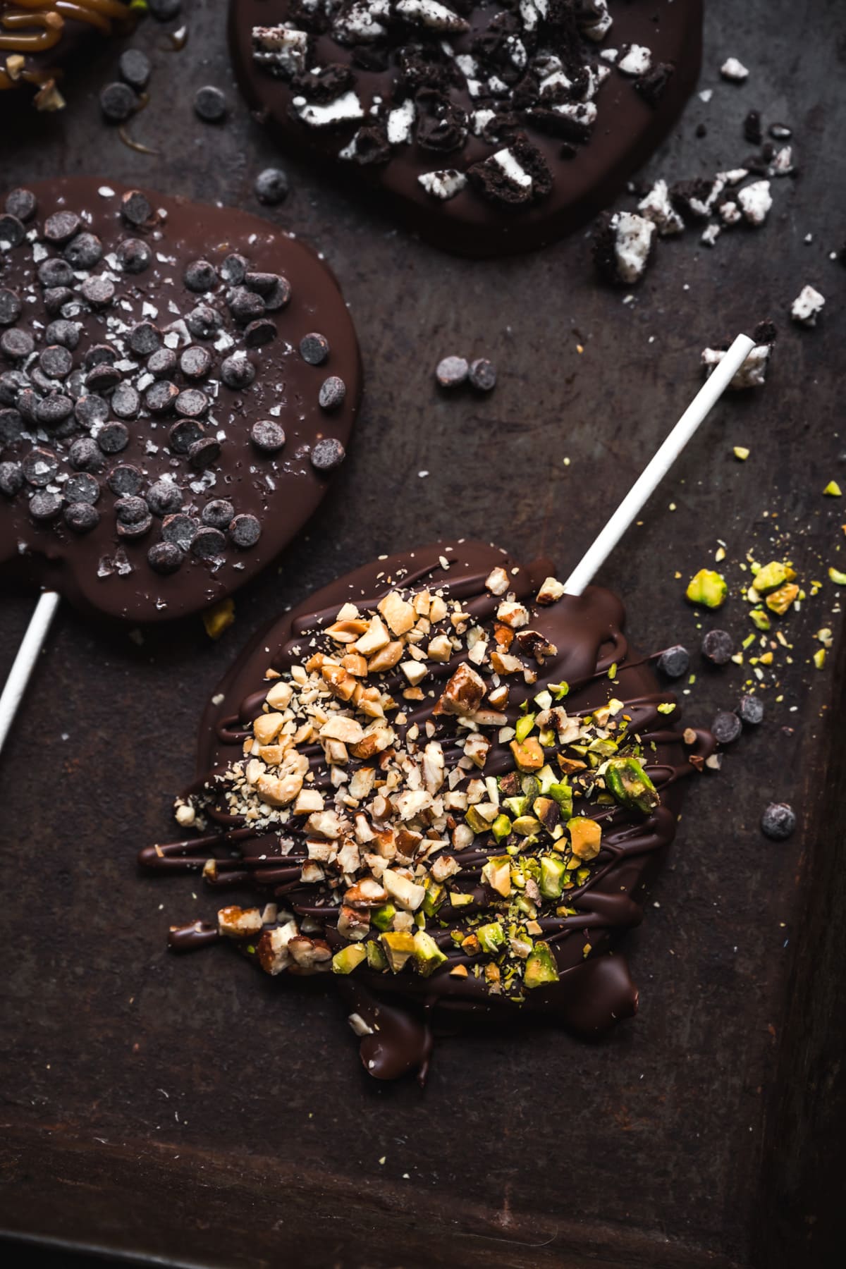 overhead view of chocolate covered apple slice with chopped nuts.