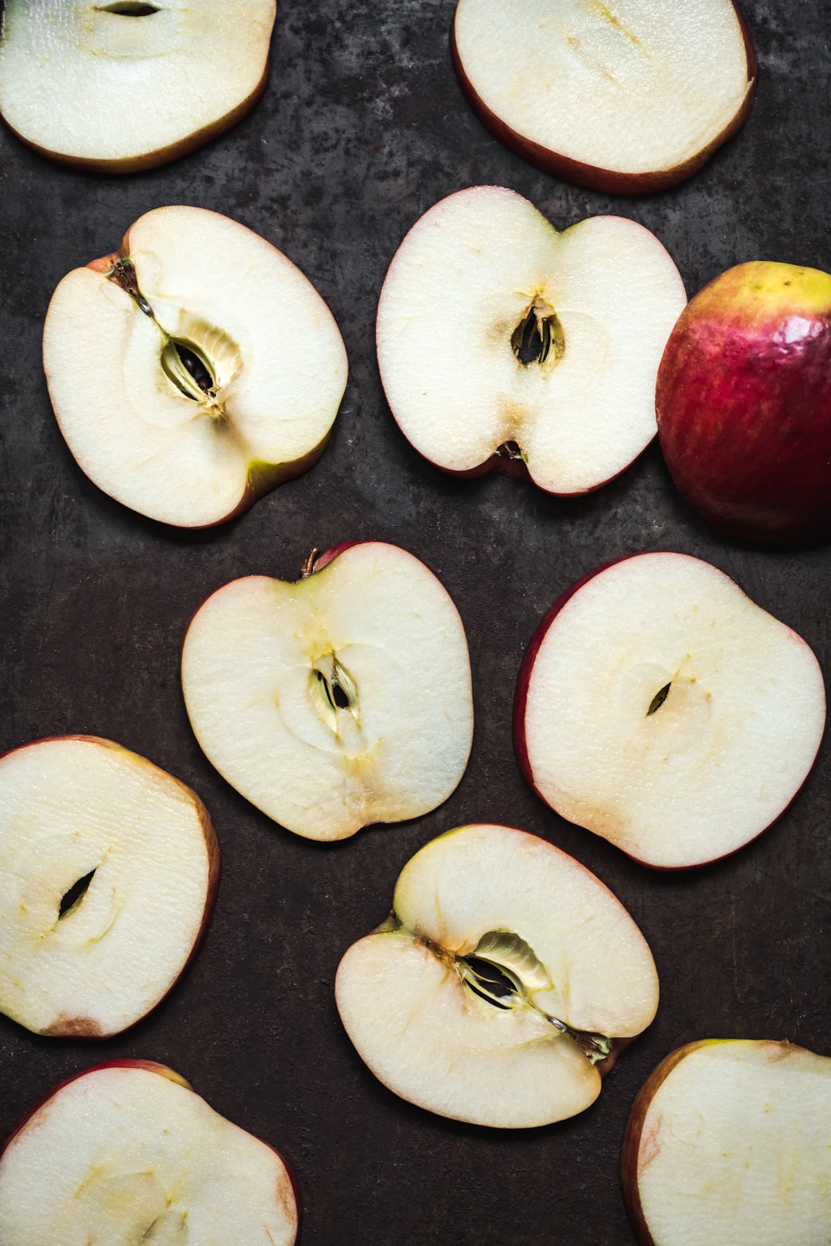 overhead view of apple slices on a sheet pan.