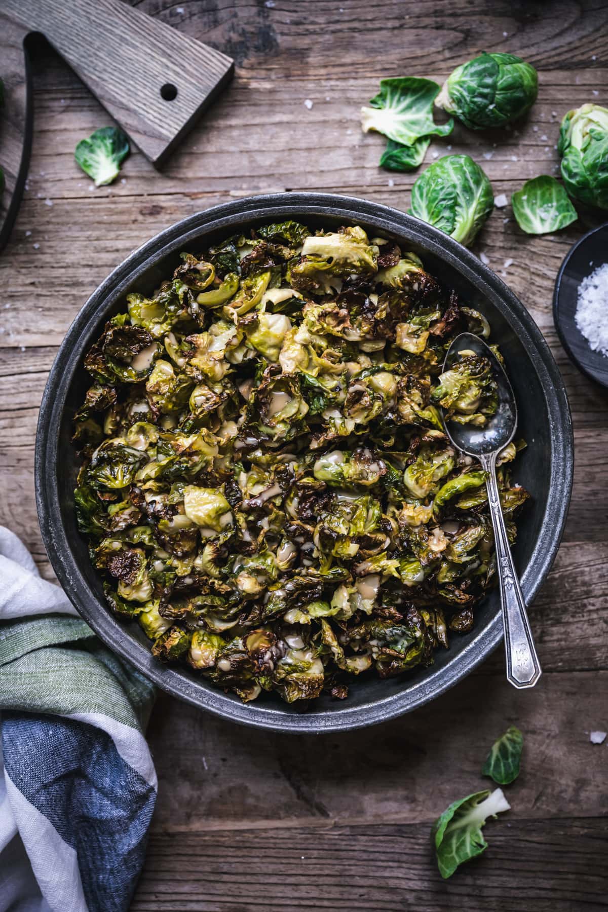 overhead view of a bowl of crispy roasted brussels sprouts with maple mustard dressing.