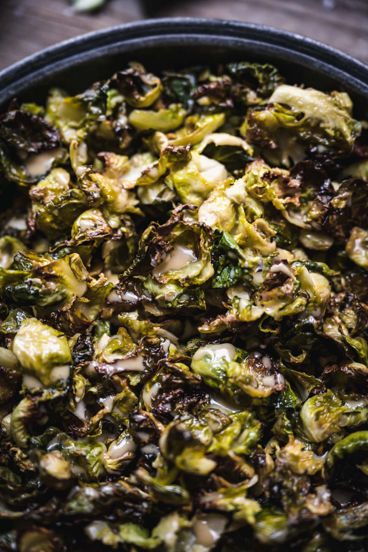 close up view of roasted brussels sprouts with maple mustard dressing.