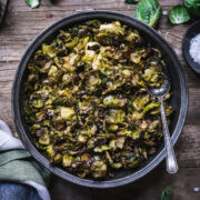overhead view of a bowl of crispy roasted brussels sprouts with maple mustard dressing.