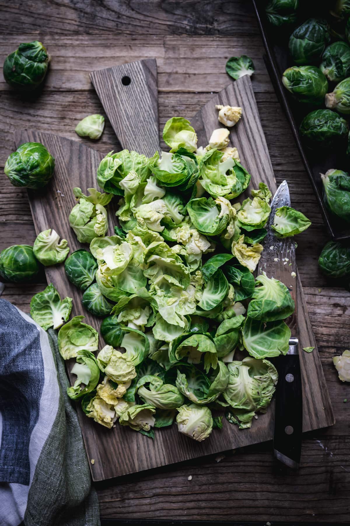 overhead view of raw brussels sprouts on cutting board.