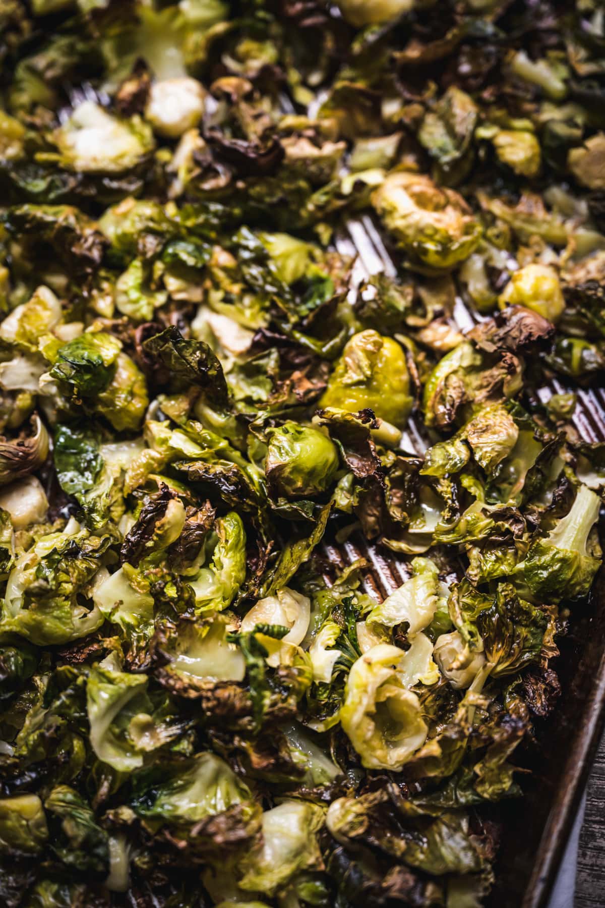 close up view of crispy roasted brussels sprouts on a baking sheet.