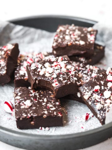 side view of circular pan filled with slices of vegan peppermint fudge.