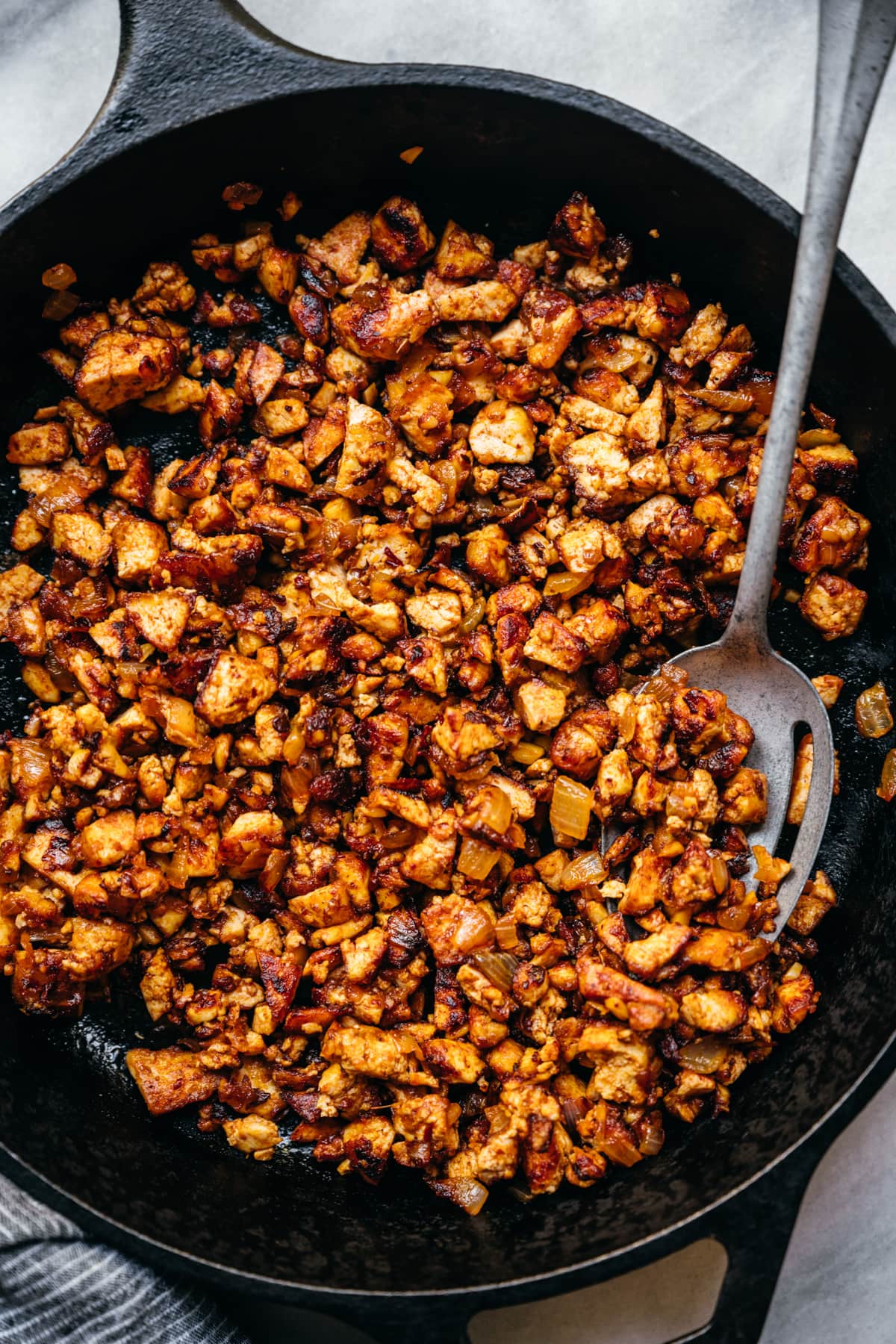 overhead view of crispy sofritas tofu in a cast iron skillet.