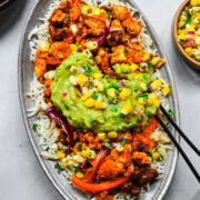 Overhead view of burrito bowl with sofritas tofu, rice, beans, salsa and guacamole.