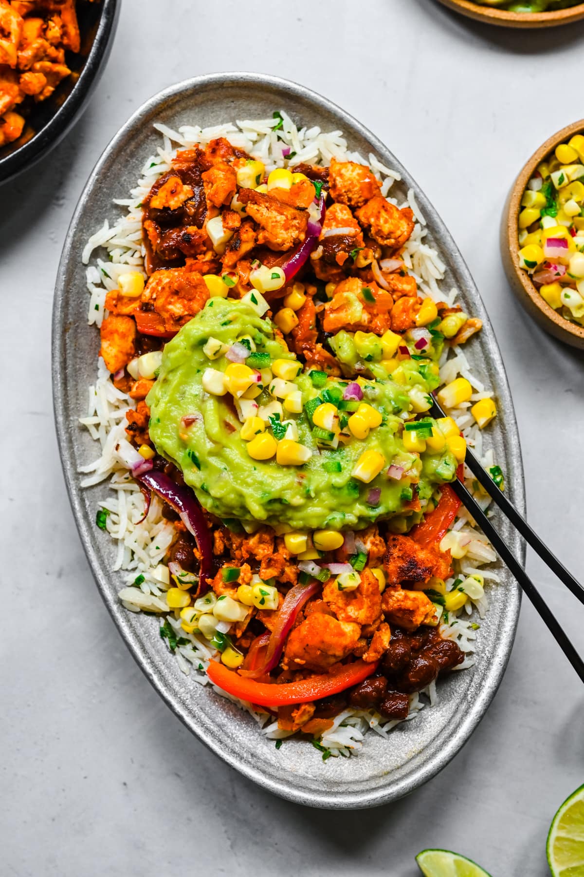 Overhead view of burrito bowl with sofritas tofu, rice, beans, salsa and guacamole. 