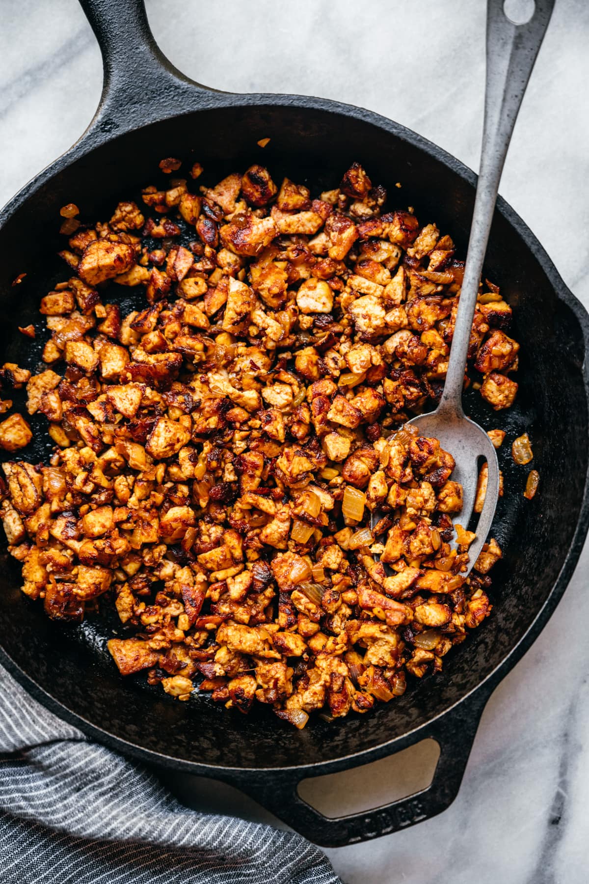 overhead view of crispy sofritas tofu in a cast iron skillet.