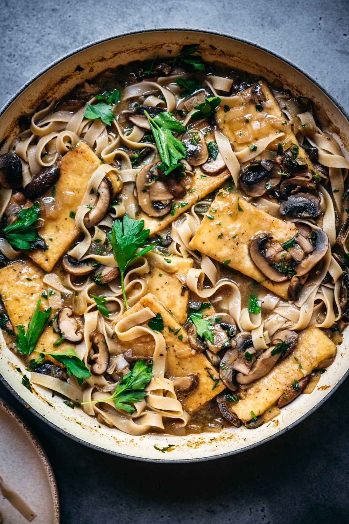 overhead view of vegan tofu marsala in a large pan.