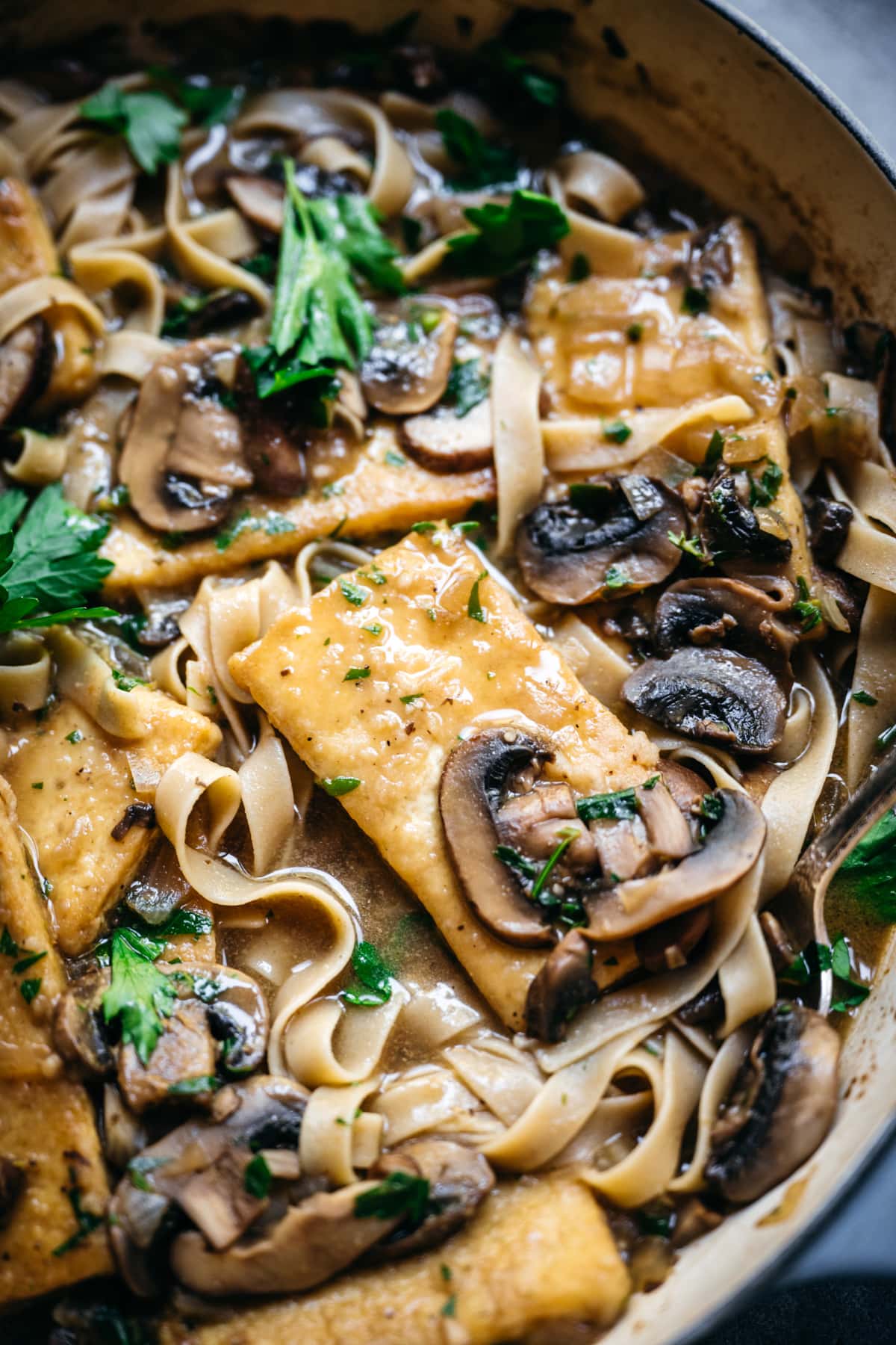 close up view of tofu marsala in a pan.