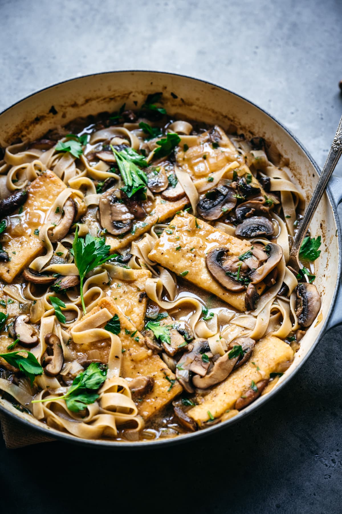 side view of vegan tofu marsala in a large pan.