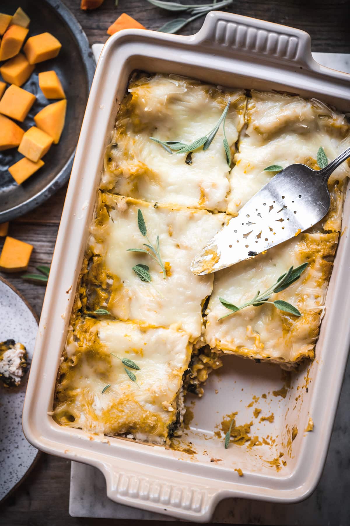 overhead view of pan of vegan butternut squash lasagna cut into slices.