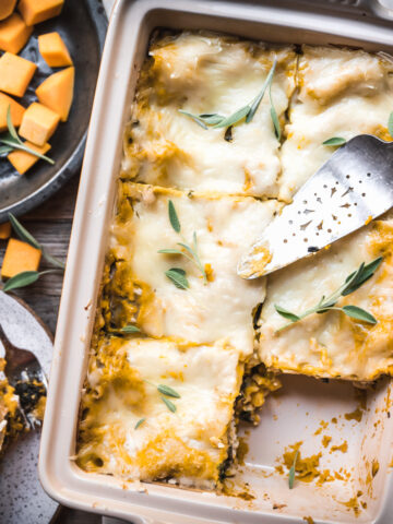 overhead view of pan of vegan butternut squash lasagna cut into slices.