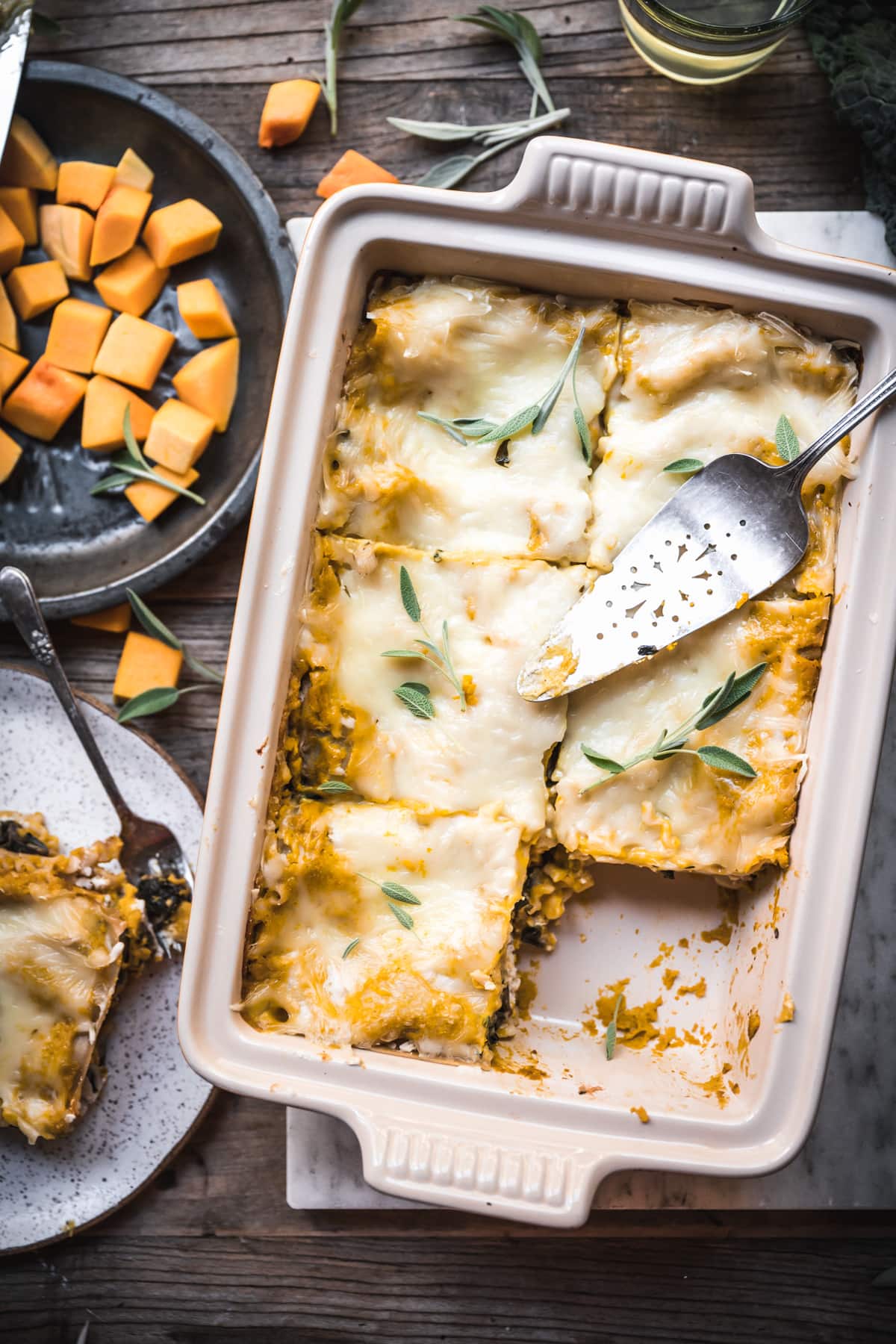 overhead view of pan of vegan butternut squash lasagna cut into slices.