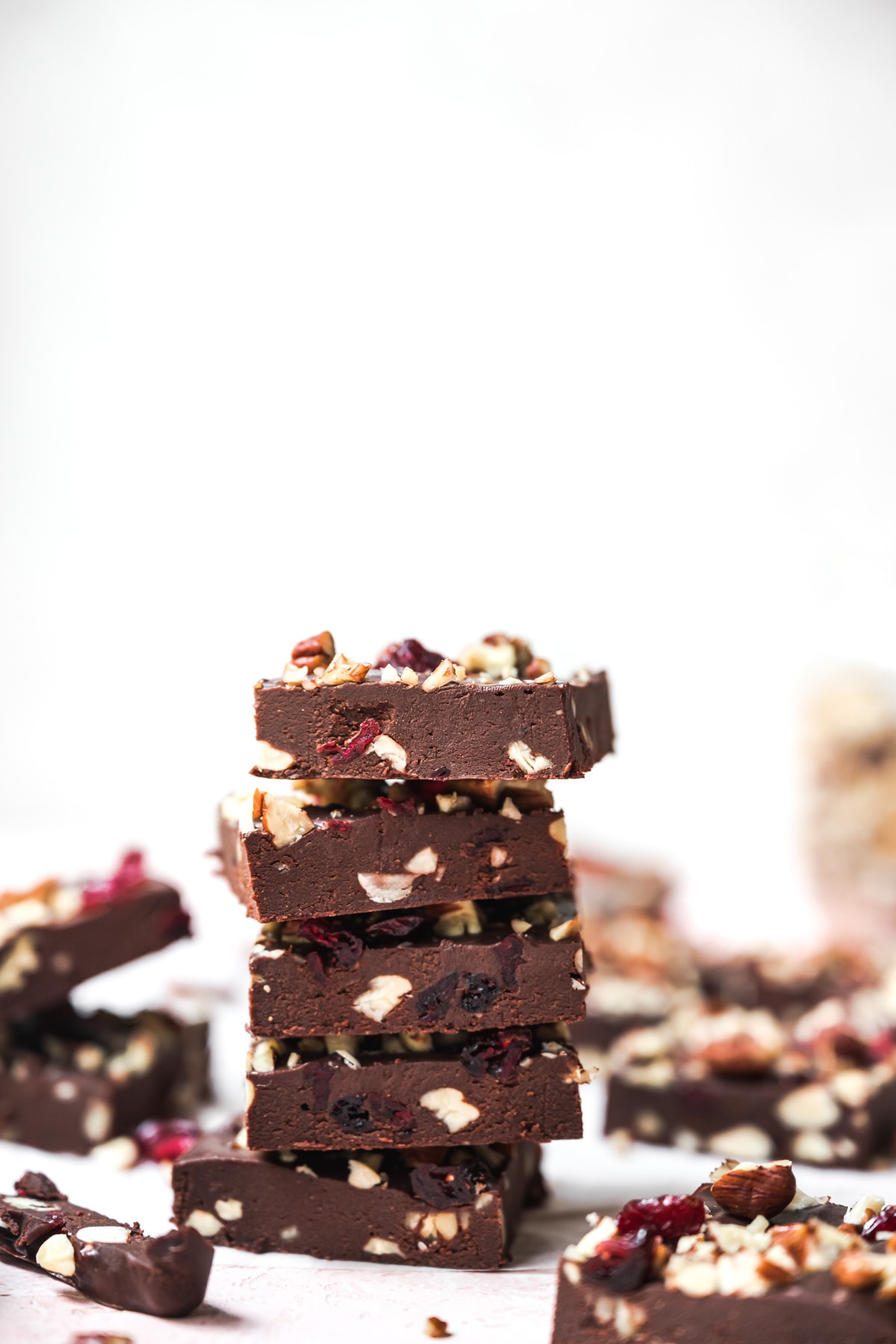 side view of a stack of vegan cranberry nut fudge. 