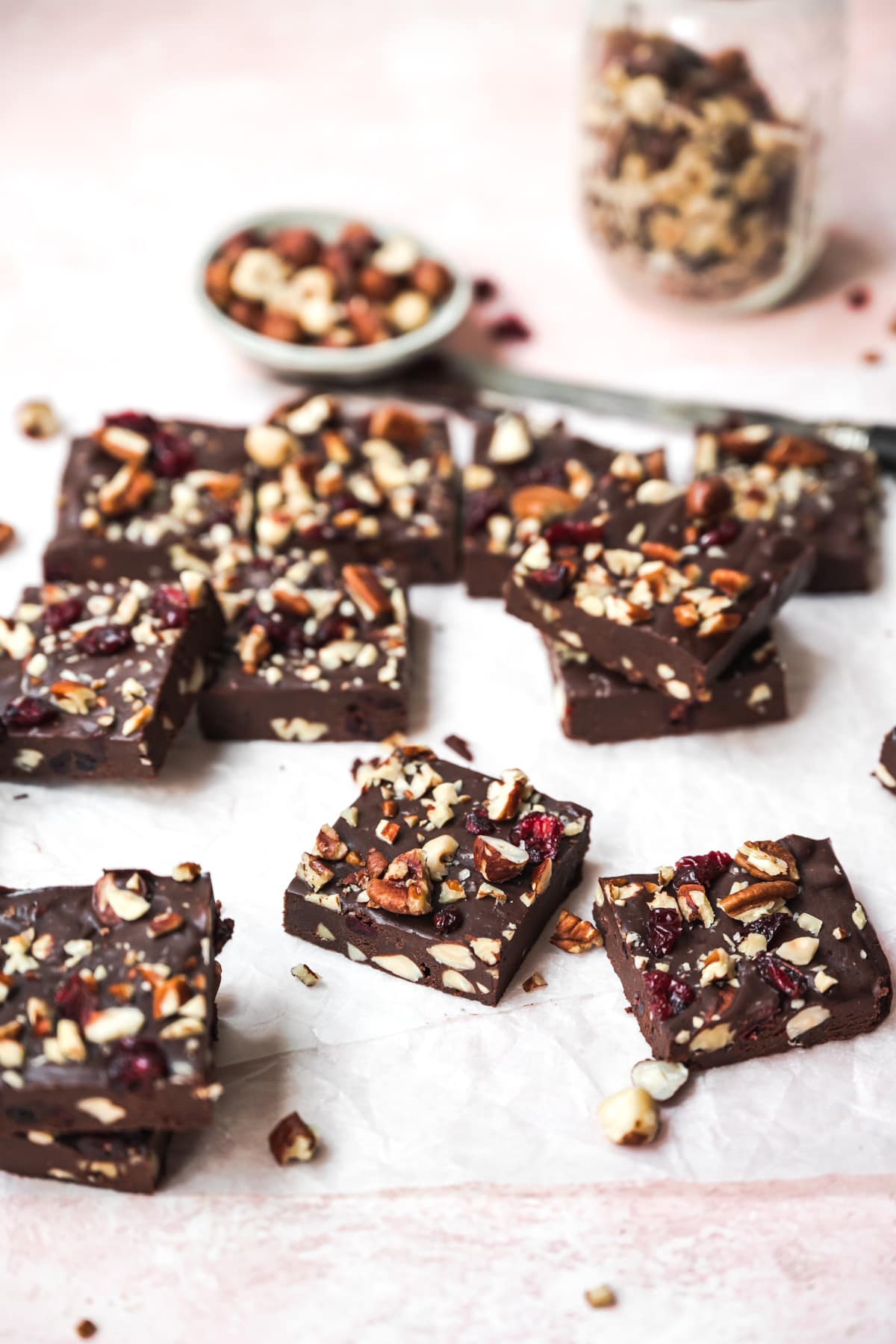 side view of slices of vegan fudge with nuts and cranberries. 