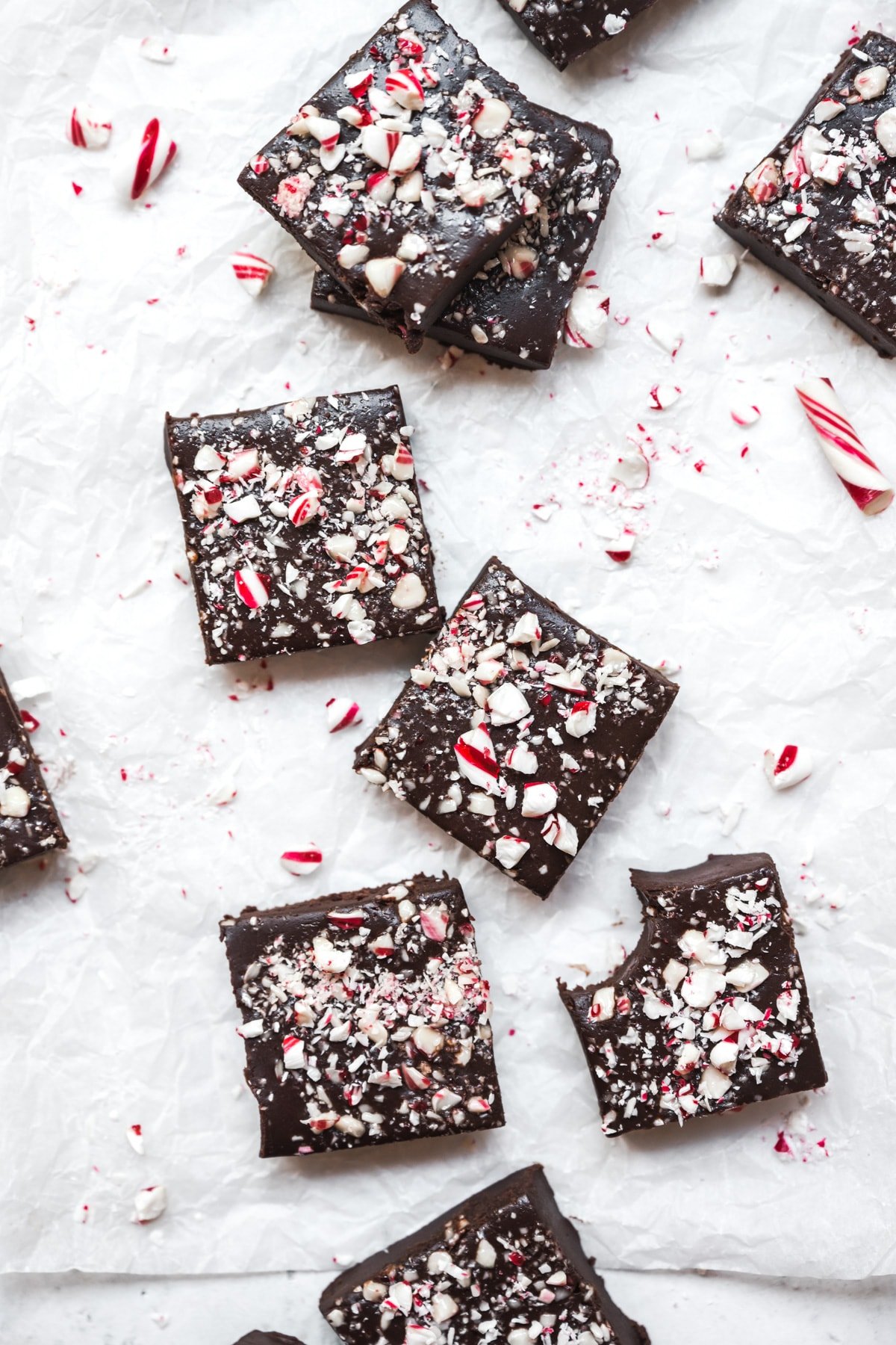 overhead view of slices of vegan peppermint fudge on parchment paper.
