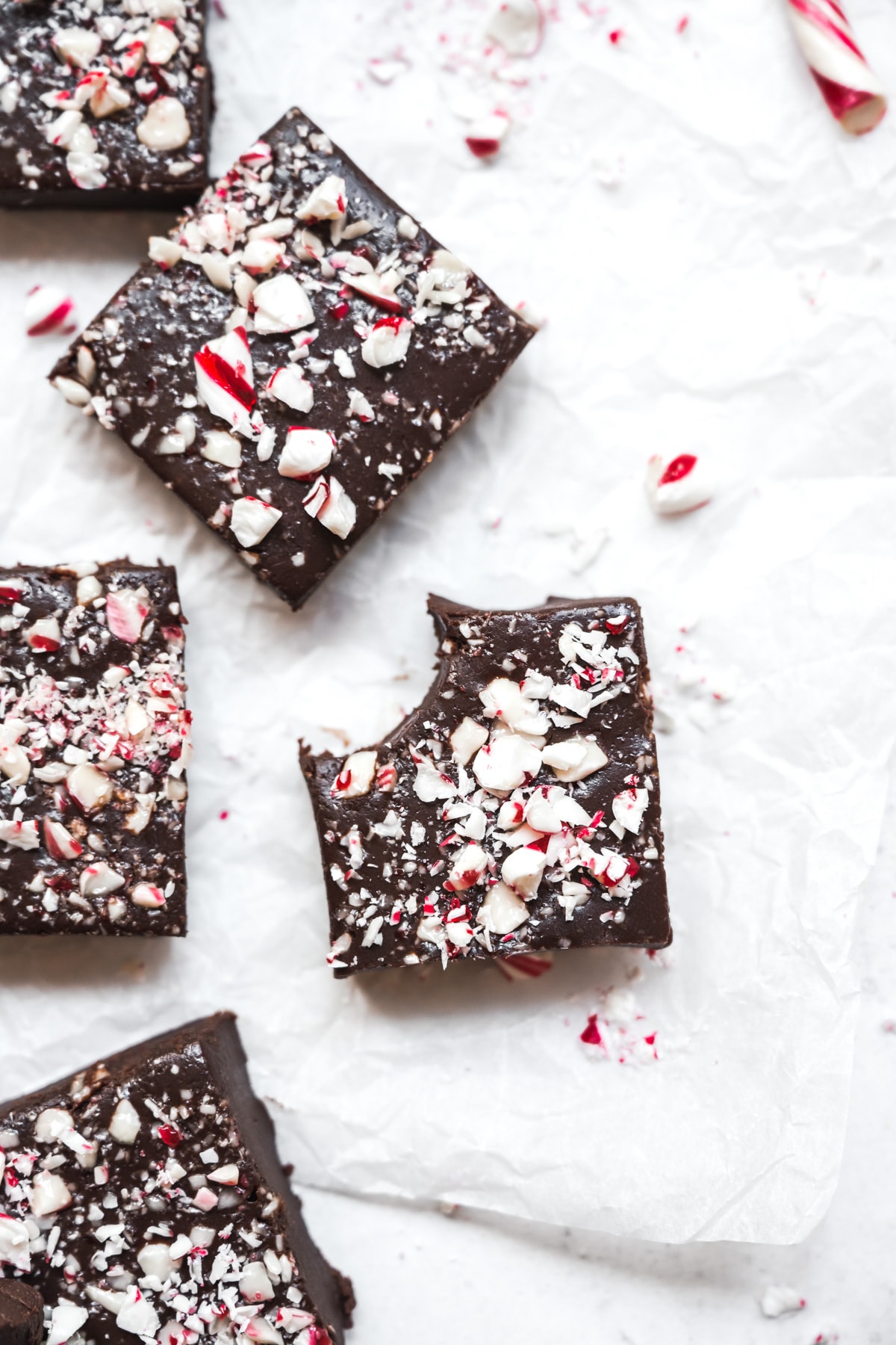 overhead view of slices of vegan peppermint fudge on parchment paper.