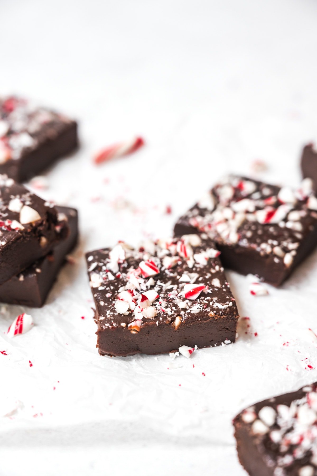 side view of slices of vegan peppermint fudge on parchment paper.
