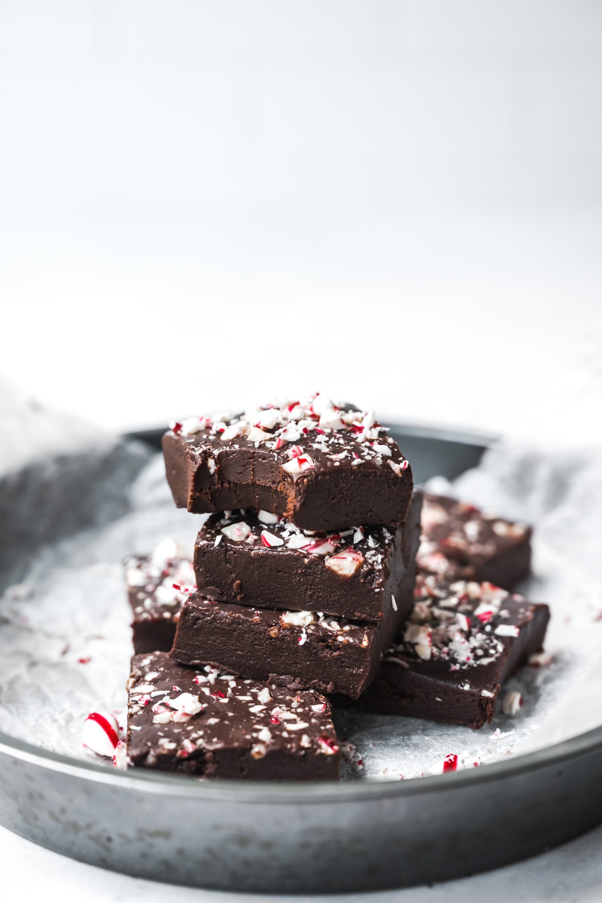 side view of circular pan filled with slices of vegan peppermint fudge. 