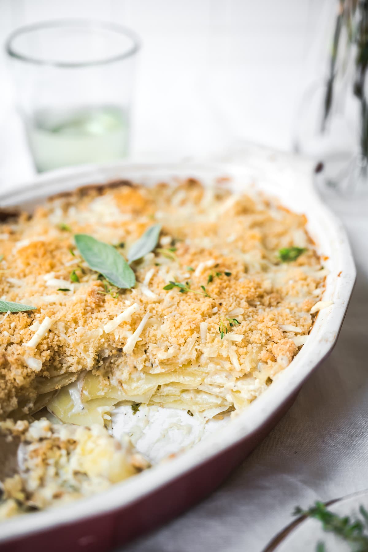 close up side view of interior of vegan scalloped potatoes in baking dish.