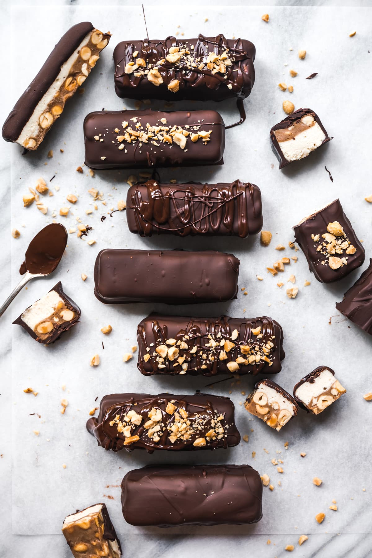 overhead view of homemade vegan snickers bars on parchment paper. 