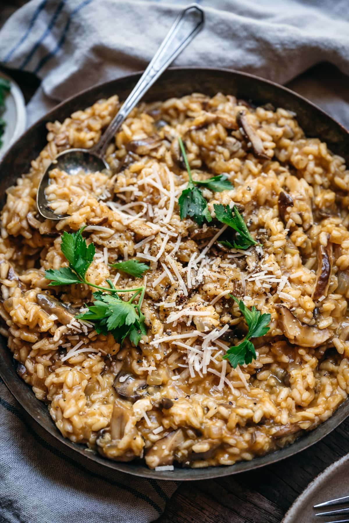 overhead view of vegan mushroom risotto in copper pan.